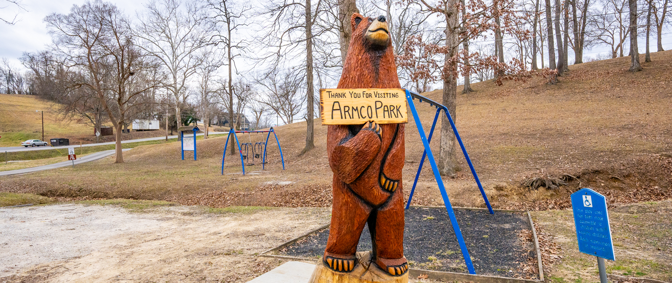 Wood Carving of Bear holding sign